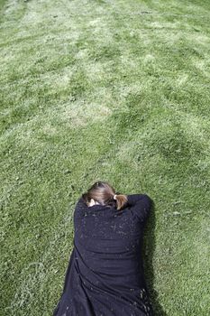 Woman lying in the grass, rest and relaxation, zen