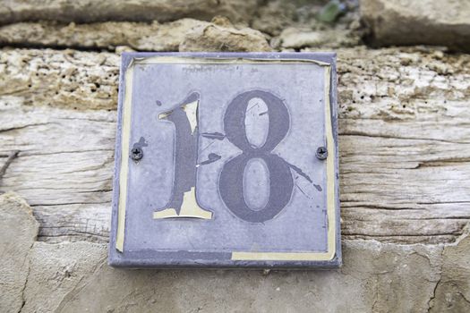Number eighteen in a wall of a house, detail of a number of information, even number