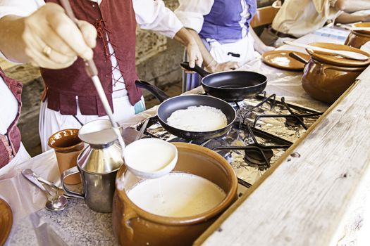Cooking pancakes on a fair, detail of a position in a market, healthy food, party