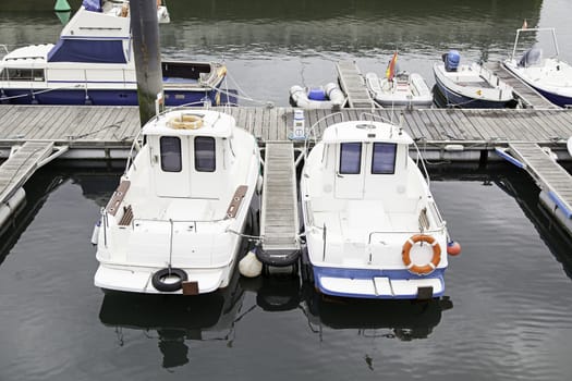 Boats moored at the dock, detail of a ship at sea, maritime transport