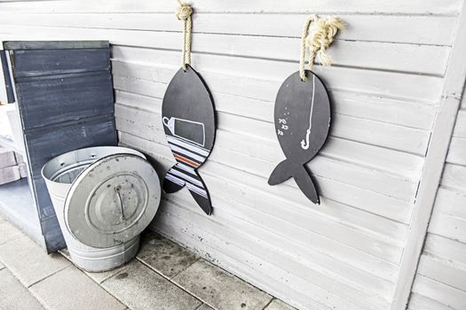 Silhouette of wooden fish, fish-shaped detail, sea