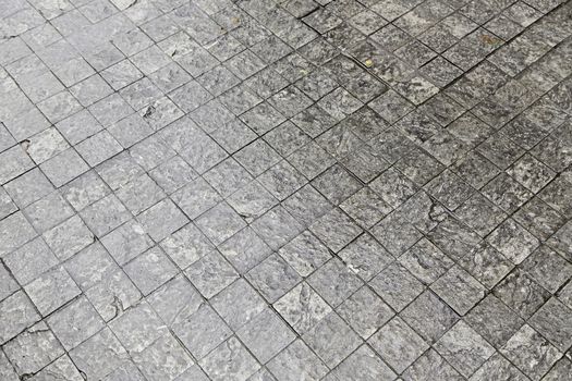 Floor wet cobblestones, detail of a textured, soil Street