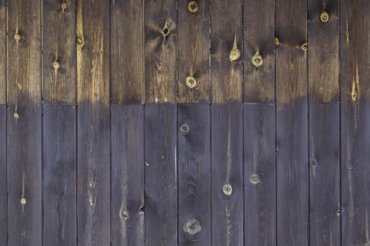 Brown wooden background, detail of a decorated wall