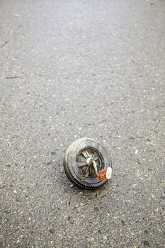 Abandoned tricycle wheel, detail of neglect and ruin, pollution