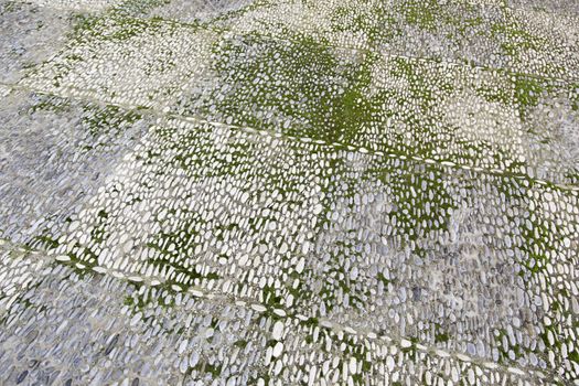 Old stone floor, detail of ground moss