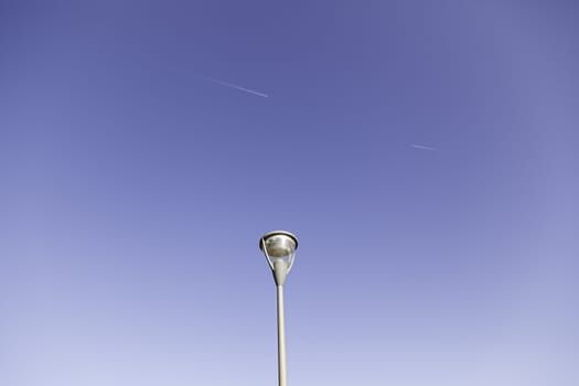 Lamp and planes in the sky, detail of air traffic, transportation