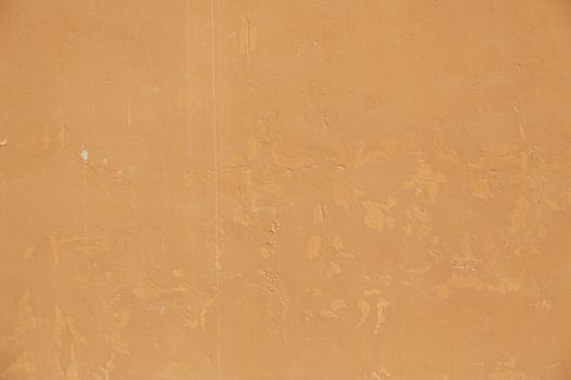 Orange cracked wall, detail of a textured, deterioration