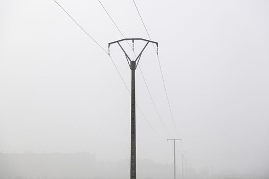 Electrical towers in the fog, detail of electric transport, energy