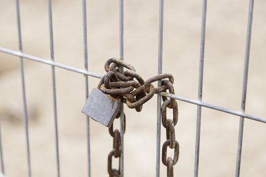 Padlocked iron gate, detail of protection and safety
