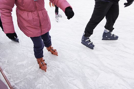 People ice skating, winter sports details