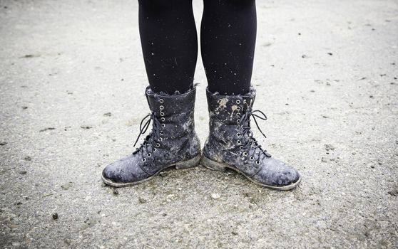 Women boots in the mud, detail of dirty boots and muddy, walk
