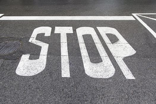 Stop sign on asphalt, detail of a road sign