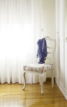 White classic chair in a living room, detail of decoration and elegance, style