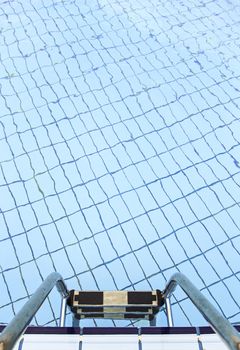 Staircase in a pool in summer, detail of access to a pool in a spa