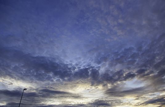 Stormy sky at dusk with street lamp, colorful sky detail