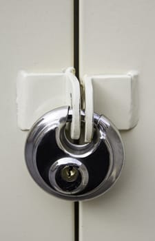 Silver padlock for protection and security, detail of anti-theft system