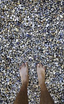 Barefoot feet on a stones, detail of relaxation, spa and zen