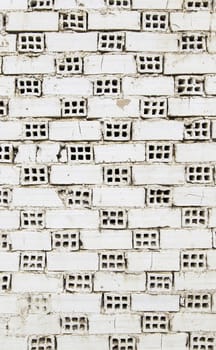 White mud bricks with holes, wall detail under construction