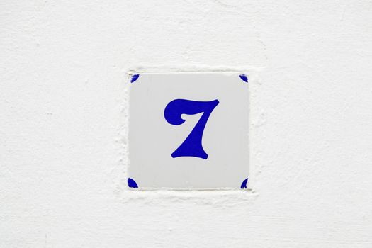 Number seven information on a wall, odd number detail, address