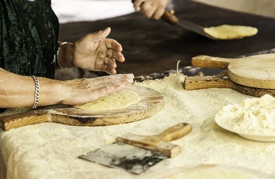 Hand kneading dough for making wheat cakes, detail of tradition, healthy food, flour