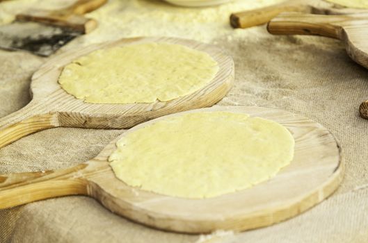 Hand kneading dough for making wheat cakes, detail of tradition, healthy food, flour