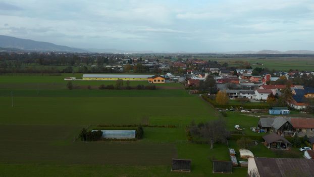 European countryside from the air, village in pannonian plain, Dravsko polje, Slovenia, rural landscape and traditional small villages with houses along the road, villages Podova and Brezula