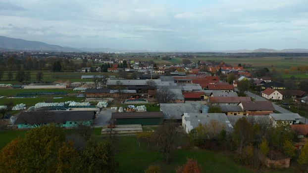 European countryside from the air, village in pannonian plain, Dravsko polje, Slovenia, rural landscape and traditional small villages with houses along the road, village Brezula and Race