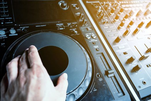 image of Dj playing music at mixer closeup