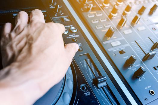 image of Dj playing music at mixer closeup