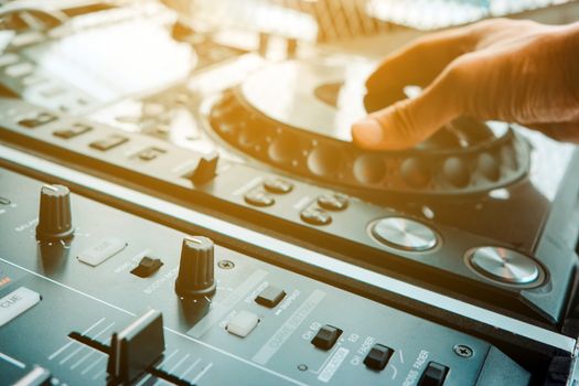 image of Dj playing music at mixer closeup