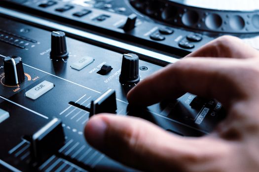 image of Dj playing music at mixer closeup