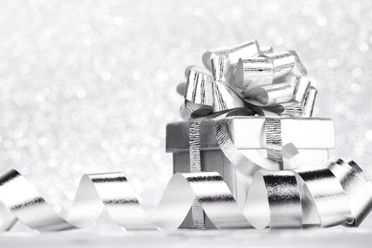 Decorative holiday Gift box and ribbon on bright shiny background