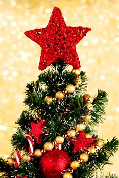 Beautiful decorated christmas tree on golden background