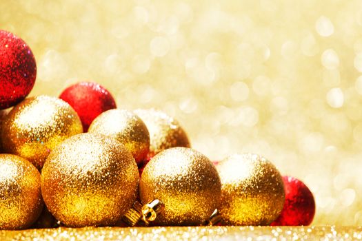 Golden Christmas ball on abstract glitter background