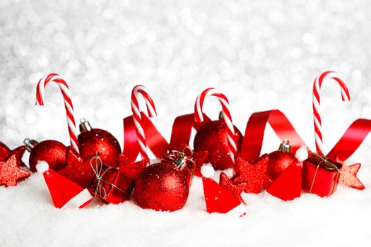 Christmas card with beautiful decorations and candies in snow
