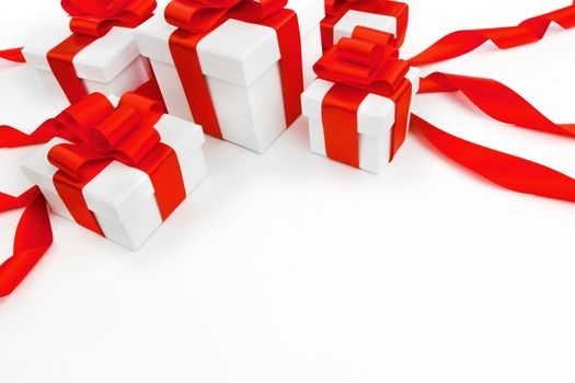 White gift boxes with red ribbons isolated on white background
