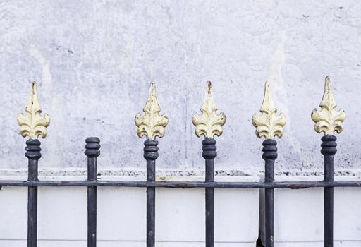 Gold painted metal gates, metal railings detail of a painted and decorated, safety and security