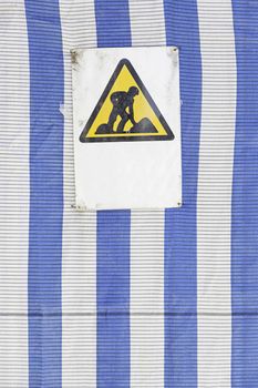 Signal construction sites, detailed information and a sign of danger, people working