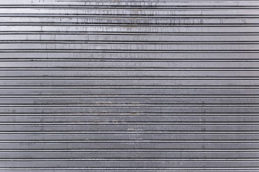 Closed rusty metal door, detail of a metallic textured background, safety and security