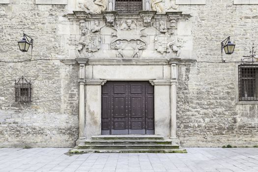 Old door in a historic building, detail of a wooden door in a very old building, background and history