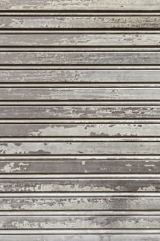 Old wooden fence, detail of a wall covered with wood protection and decoration, dirty and abandoned