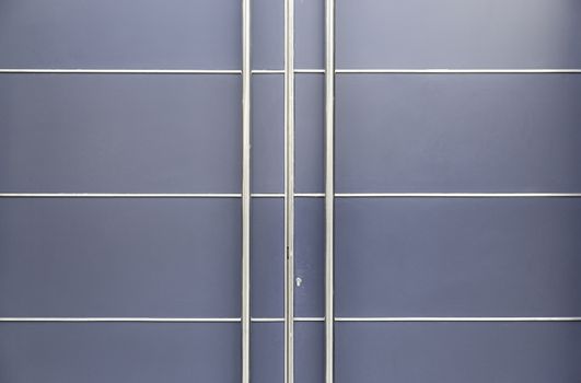 Modern metal door, detail of a door in a modern building architecture and protection
