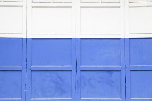 Blue and white door, detail of a door in a city, painting and decoration, protection, closed