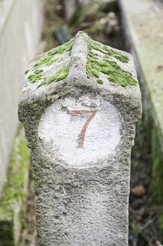 Number seven on a stone detail of a carved stone number, decoration, neglect and ruin