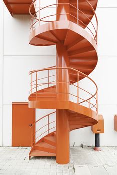 Red spiral staircase, detail of an access ladder on the outside, red décor
