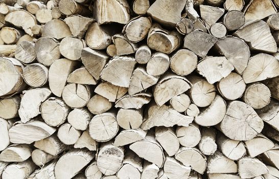 Cut firewood, detail of pieces of wood to a wood background with natural texture