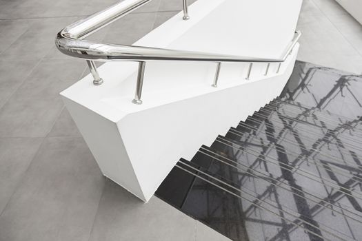 Black marble stairs, detail of stairs with metal railing and white, modern architecture, reflection and cleaning