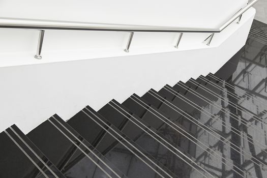 Black marble stairs, detail of stairs with metal railing and white, modern architecture, reflection and cleaning