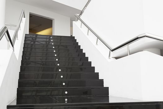 Black marble stairs, detail of the interior of a modernist building, modern architecture