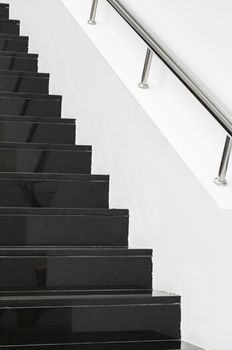 Black marble stairs, detail of the interior of a modernist building, modern architecture